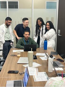 A group of residents looking at a computer screen